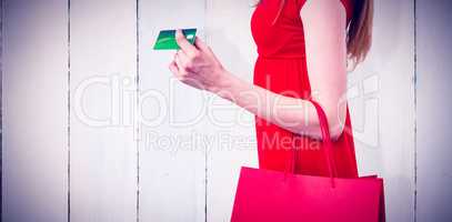Composite image of woman shopping with her credit card