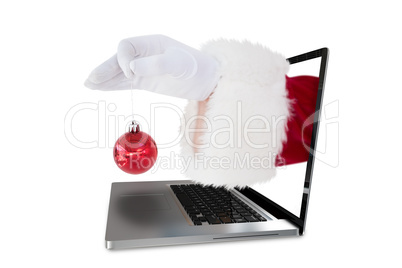 Composite image of santa claus holding red bauble