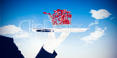 Composite image of hand with gloves holding a silver tray