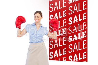 Composite image of buisnesswoman posing with boxing gloves