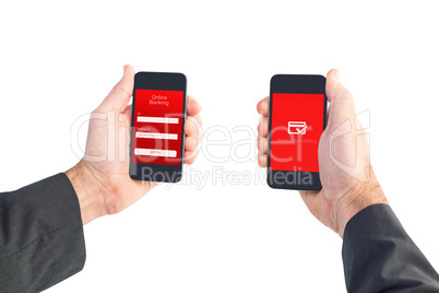 Composite image of businessman holding two smart phones