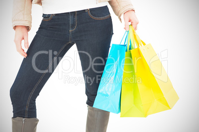 Mid section of woman holding shopping bags