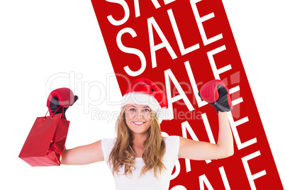 Composite image of festive blonde with boxing gloves and shoppin