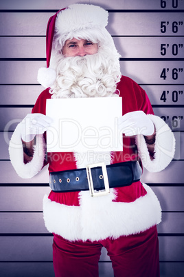 Composite image of smiling santa claus holding page