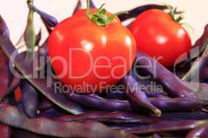 red tomatoes and lilac pods of haricot