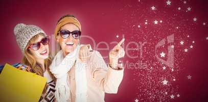 Composite image of beautiful women holding shopping bags pointin