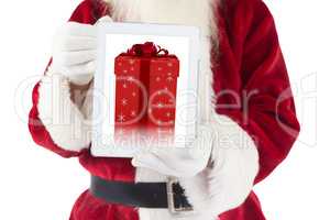 Composite image of santa claus showing tablet pc