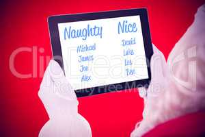 Composite image of santa claus using tablet pc