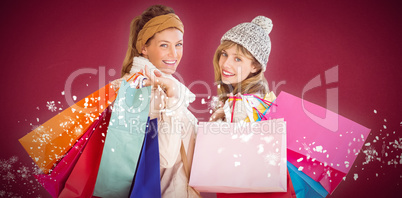 Composite image of beautiful women holding shopping bags looking