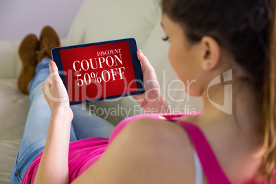 Composite image of woman using tablet at home