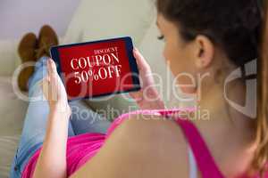 Composite image of woman using tablet at home