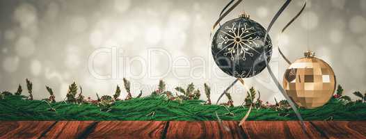 Composite image of hanging christmas bauble decorations