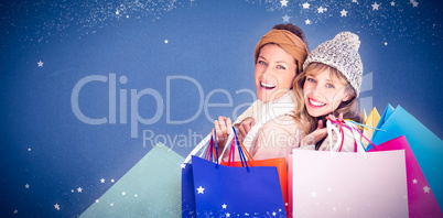 Composite image of beautiful women holding shopping bags looking