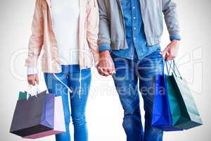 Couple with shopping bags holding hands