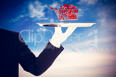 Composite image of hand with gloves holding a silver tray