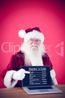 Composite image of happy santa showing laptop screen