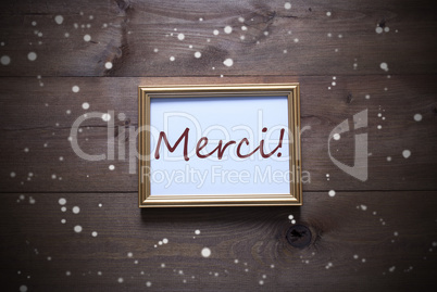 Golden Picture Frame With Merci Means Thank You And Snowflakes