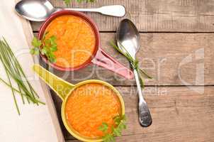 Carrot soup on a wooden table