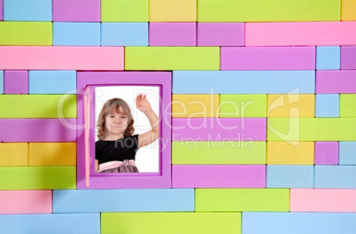 little girl greeting on window