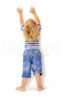 Back view of little boy with hands up