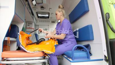 Emergency medical service female paramedic working at the site of illness or injury