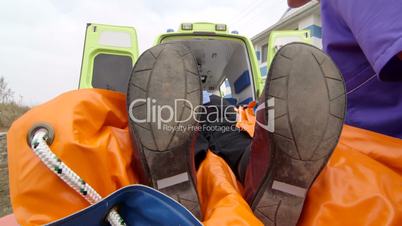 Emergency medical technicians and paramedics loading patient into an ambulance