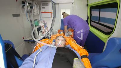 Emergency medical service senior person in ambulance during transport to hospital
