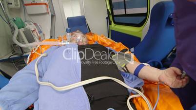 EMT provide emergency medical care to patient in ambulance intravenous infusion