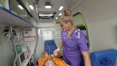 Senior person receiving medication via intravenous therapy in ambulance