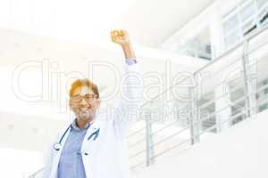 Excited Asian Indian medical doctor celebrating success