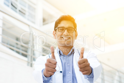 Asian Indian medical doctor thumbs up and smiling
