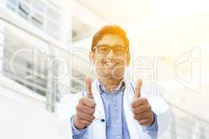 Asian Indian medical doctor thumbs up and smiling
