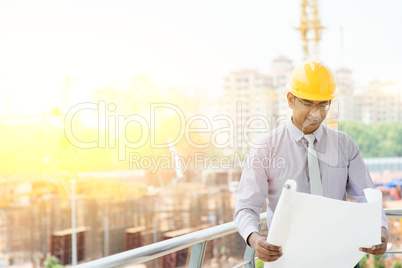 Asian Indian male site contractor engineer inspecting at site