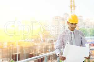 Asian Indian male site contractor engineer inspecting at site