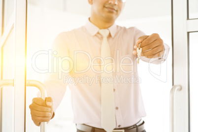 Asian Indian people holding office key