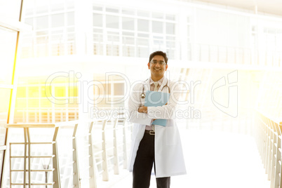 Asian Indian medical doctor holding medical report