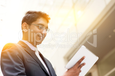 Asian Indian businessman using tablet computer