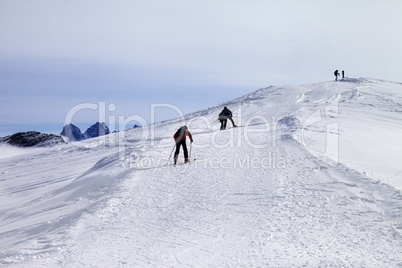 Skiers on ski slope at wind day
