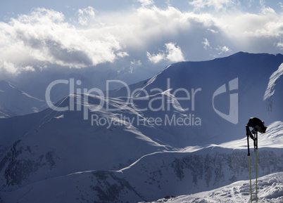 Evening sunlight mountains and ski equipment