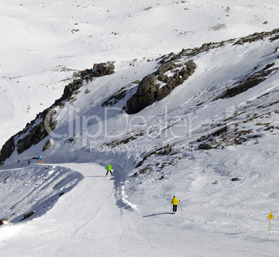 Snowboarders and skiers on groomed slope