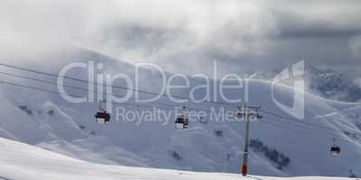 Panoramic view on gondola lifts and off-piste slope in mist