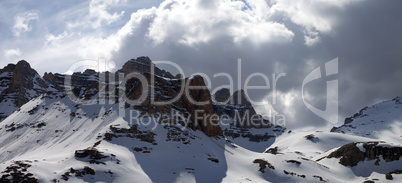 Panoramic view on winter mountains in storm clouds