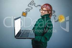 Teenage boy in glasses holding a laptop charging cord plug wire