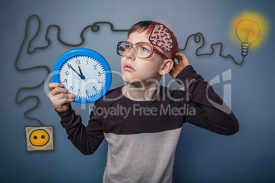 Teenage boy scratching his head and holding a clock booster char