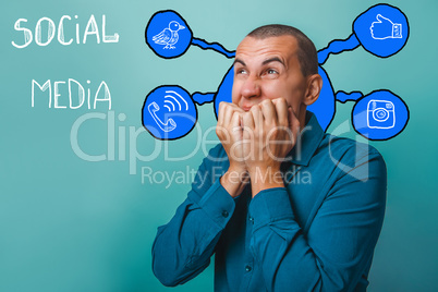 Male businessman chewing fingers on his hand raised to his mouth