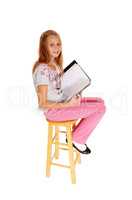 Schoolgirl sitting with her schoolbook.