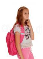Schoolgirl thinking with backpack.