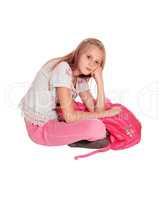 Sad looking girl with pink backpack.