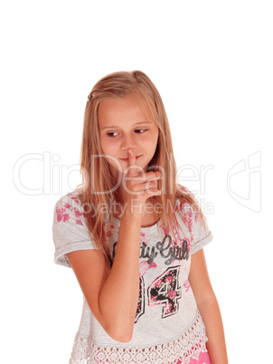 Young pretty girl with finger over mouth.