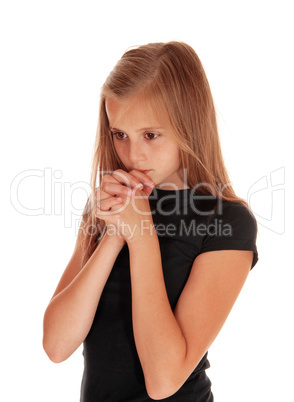 Girl standing in profile and praying.